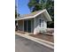 Exterior of leasing office with sliding glass doors and a flower bed with pink and gray flowers at 5206 Sweetwater Blvd. # 5206, Murrells Inlet, SC 29576