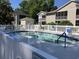 Community swimming pool surrounded by white picket fence with a small shed building nearby at 5206 Sweetwater Blvd. # 5206, Murrells Inlet, SC 29576