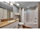 Bright bathroom with a single sink vanity, and tub/shower with white tile surround at 5300 N Ocean Blvd. N # 1120, Myrtle Beach, SC 29577