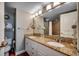 Bathroom featuring granite countertop, double sinks, and a well-lit vanity mirror at 5300 N Ocean Blvd. N # 1120, Myrtle Beach, SC 29577