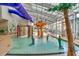 Indoor water park featuring sprinklers, slides, and tropical decor at 5300 N Ocean Blvd. N # 1120, Myrtle Beach, SC 29577