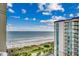Gorgeous ocean view from the balcony, overlooking the beach with palm trees and resort amenities at 5300 N Ocean Blvd. N # 1120, Myrtle Beach, SC 29577