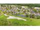 Aerial view of a golf course community with homes lining the pond and fairway at 535 Wildflower Trail, Myrtle Beach, SC 29579