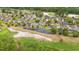 Aerial view of neighborhood bordering a golf course and pond, creating a serene environment at 535 Wildflower Trail, Myrtle Beach, SC 29579