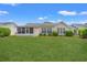 Home's backyard featuring lush lawn and a screened-in porch at 535 Wildflower Trail, Myrtle Beach, SC 29579