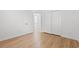 Bright bedroom with light wood floors, open doorway to bath, and large closet at 535 Wildflower Trail, Myrtle Beach, SC 29579