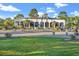 Exterior view of the Myrtle Beach National clubhouse with lush landscaping and golf carts at 535 Wildflower Trail, Myrtle Beach, SC 29579