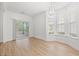 Bright dining area featuring large windows and a sliding glass door to the screened porch, providing natural light at 535 Wildflower Trail, Myrtle Beach, SC 29579