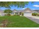 Charming single-story home featuring manicured lawn, blue shutters, and an attached two-car garage at 535 Wildflower Trail, Myrtle Beach, SC 29579
