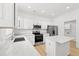 Modern kitchen features stainless steel appliances, white cabinets, marble countertops, and an island for food preparation at 535 Wildflower Trail, Myrtle Beach, SC 29579