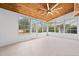 Bright sunroom featuring wood ceiling, tile floors, and walls of windows at 535 Wildflower Trail, Myrtle Beach, SC 29579