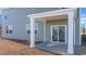Covered patio with white support beams and sliding glass door with view of lake at 586 Strawberry Field Way, Galivants Ferry, SC 29544