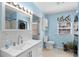 Bathroom featuring a single sink vanity and tiled shower, with blue walls and decor at 6001 - 1805 S Kings Hwy., Myrtle Beach, SC 29575