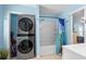 Efficient bathroom featuring a stacked washer and dryer, along with a tub and shower combo at 6001 - 1805 S Kings Hwy., Myrtle Beach, SC 29575