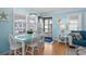 Bright dining area features a blue table and plenty of natural light at 6001 - 1805 S Kings Hwy., Myrtle Beach, SC 29575