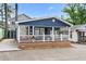 Inviting blue home showcases its charming front porch and welcoming appeal at 6001 - 1805 S Kings Hwy., Myrtle Beach, SC 29575