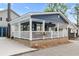 Quaint blue home featuring a cozy covered front porch at 6001 - 1805 S Kings Hwy., Myrtle Beach, SC 29575