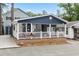 Charming home featuring a spacious porch with white railings and wood details, creating a welcoming entrance at 6001 - 1805 S Kings Hwy., Myrtle Beach, SC 29575
