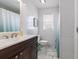 Bathroom featuring white tile, a dark vanity, a large mirror, and natural light from a window at 6001-1454 S Kings Hwy., Myrtle Beach, SC 29575