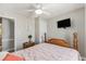 Bedroom featuring hardwood floors, a ceiling fan, a TV, and a wooden bed frame at 6001-1454 S Kings Hwy., Myrtle Beach, SC 29575