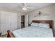 Cozy bedroom featuring a wooden headboard bed, white double-door closet, and decorative blue wall art for a personalized touch at 6001-1454 S Kings Hwy., Myrtle Beach, SC 29575