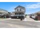 Quaint two-story house boasting a welcoming porch, manicured surroundings, and proximity to neighboring homes at 6001-1454 S Kings Hwy., Myrtle Beach, SC 29575