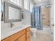 Bright bathroom with a vanity, framed mirror, tile flooring, and a shower-tub combination with curtain at 603 Sea Island Way, North Myrtle Beach, SC 29582