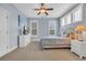 Serene blue bedroom with white furniture, a large window, soft carpet, and stylish decor at 603 Sea Island Way, North Myrtle Beach, SC 29582