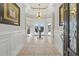 A bright foyer featuring tile flooring, a chandelier, and a view of the outdoor seating area at 603 Sea Island Way, North Myrtle Beach, SC 29582