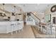 Bright space with kitchen island and dining area with access to an adjacent room via hardwood stairs at 603 Sea Island Way, North Myrtle Beach, SC 29582