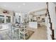Open-concept living space features hardwood table, natural light, and modern kitchen island for convenience at 603 Sea Island Way, North Myrtle Beach, SC 29582