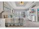 Spacious main bedroom with tray ceiling, waterfront view, and access to balcony at 603 Sea Island Way, North Myrtle Beach, SC 29582