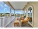 Covered patio with comfortable wicker furniture overlooking a picturesque lake and community at 603 Sea Island Way, North Myrtle Beach, SC 29582