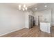 Open dining area with modern lighting, hardwood floors, and stainless steel appliances at 608 Woodside Dr., Conway, SC 29526