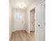 Bright entryway with hardwood floors, a white front door with glass panes, and white trim throughout at 608 Woodside Dr., Conway, SC 29526
