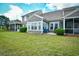 Spacious backyard featuring a well-maintained lawn, patio, and neutral-colored siding at 6172 Catalina Dr. # 515, North Myrtle Beach, SC 29582
