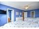 Cozy blue bedroom featuring two beds, a dresser, and a view into a bathroom, creating a relaxing coastal-inspired space at 6172 Catalina Dr. # 515, North Myrtle Beach, SC 29582