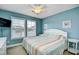 Comfortable bedroom with two windows for natural light, a ceiling fan, and neutral carpet adding to the calming atmosphere at 6172 Catalina Dr. # 515, North Myrtle Beach, SC 29582