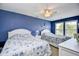 Bedroom featuring blue walls, two twin beds, ceiling fan, and windows at 6172 Catalina Dr. # 515, North Myrtle Beach, SC 29582