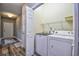 Convenient laundry room featuring a washer, dryer, and storage shelves, located near the entryway at 6172 Catalina Dr. # 515, North Myrtle Beach, SC 29582