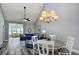 Open living area with vaulted ceiling, wood floors, and modern chandelier above the dining table at 6172 Catalina Dr. # 515, North Myrtle Beach, SC 29582