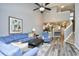 Living room featuring a blue sofa, open layout, gray walls, ceiling fan, and staircase at 6172 Catalina Dr. # 515, North Myrtle Beach, SC 29582