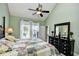 Main bedroom with green walls, high ceiling, dark furniture, and view to the backyard at 6172 Catalina Dr. # 515, North Myrtle Beach, SC 29582