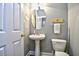 Cozy powder room features a pedestal sink, oval mirror, and toilet, maximizing the space in a charming design at 6172 Catalina Dr. # 515, North Myrtle Beach, SC 29582