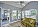 Bright sunroom with multiple windows, a cozy patterned couch, and tiled floors creating an airy and relaxing space at 6172 Catalina Dr. # 515, North Myrtle Beach, SC 29582
