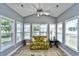 Bright sunroom filled with natural light from many windows and a patterned sofa, creating a relaxing space at 6172 Catalina Dr. # 515, North Myrtle Beach, SC 29582