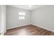 Bedroom features hardwood floors, neutral walls, and a window at 6304 Timberline Dr. # B, Myrtle Beach, SC 29572