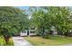 Charming home featuring a blue front door and lush landscaping at 6304 Timberline Dr. # B, Myrtle Beach, SC 29572