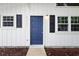 Home featuring a blue front door with black shutters and manicured landscape at 6304 Timberline Dr. # B, Myrtle Beach, SC 29572