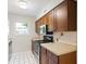Kitchen with wood cabinets, stainless steel appliances, and white tile floors at 6304 Timberline Dr. # B, Myrtle Beach, SC 29572